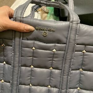 New with tags. Grey. Slides over luggage.
Very spacious and lightweight.